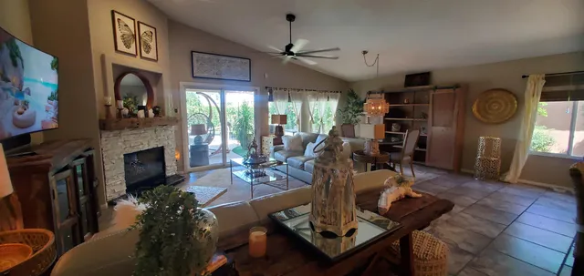 a living room with furniture a fireplace and a flat screen tv
