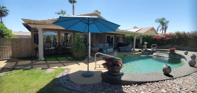 a swimming pool with outdoor seating yard and patio
