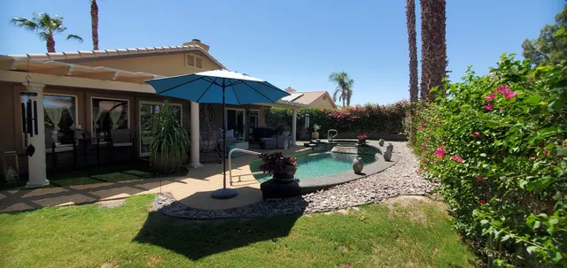 a swimming pool with outdoor seating yard and patio