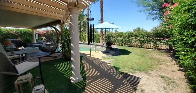 a view of a patio with table and chairs potted plants with wooden floor