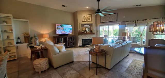 a living room with fireplace furniture and a flat screen tv