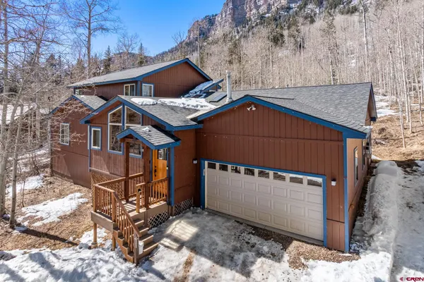 a front view of a house with parking space