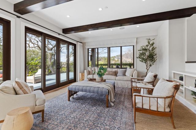 a roof deck with couches and wooden floor