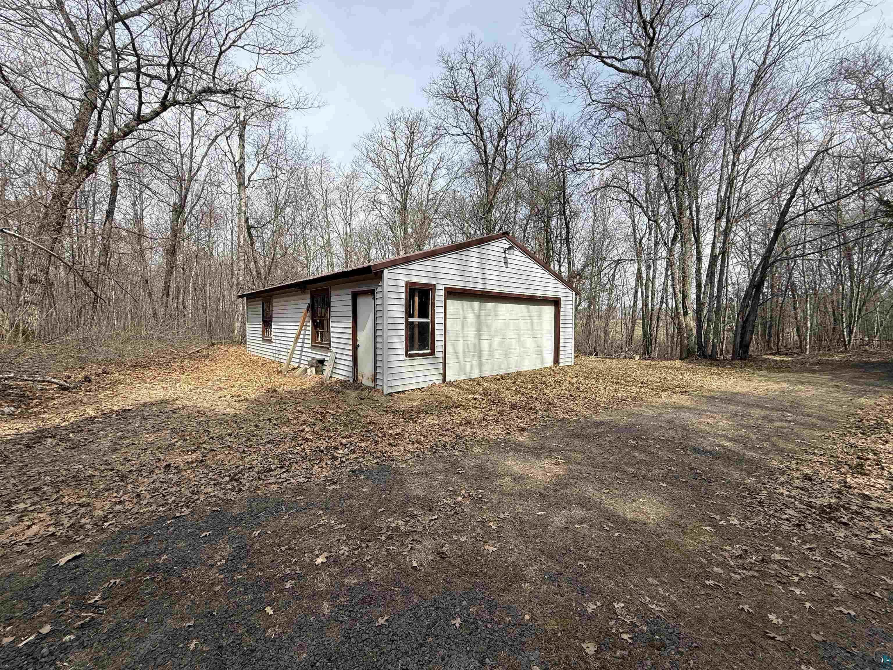 9410 Pine Lake Road Iron River, WI 54847 - Photo 30 of 31 Detached garage building featuring white siding, a single garage door, and multiple windows