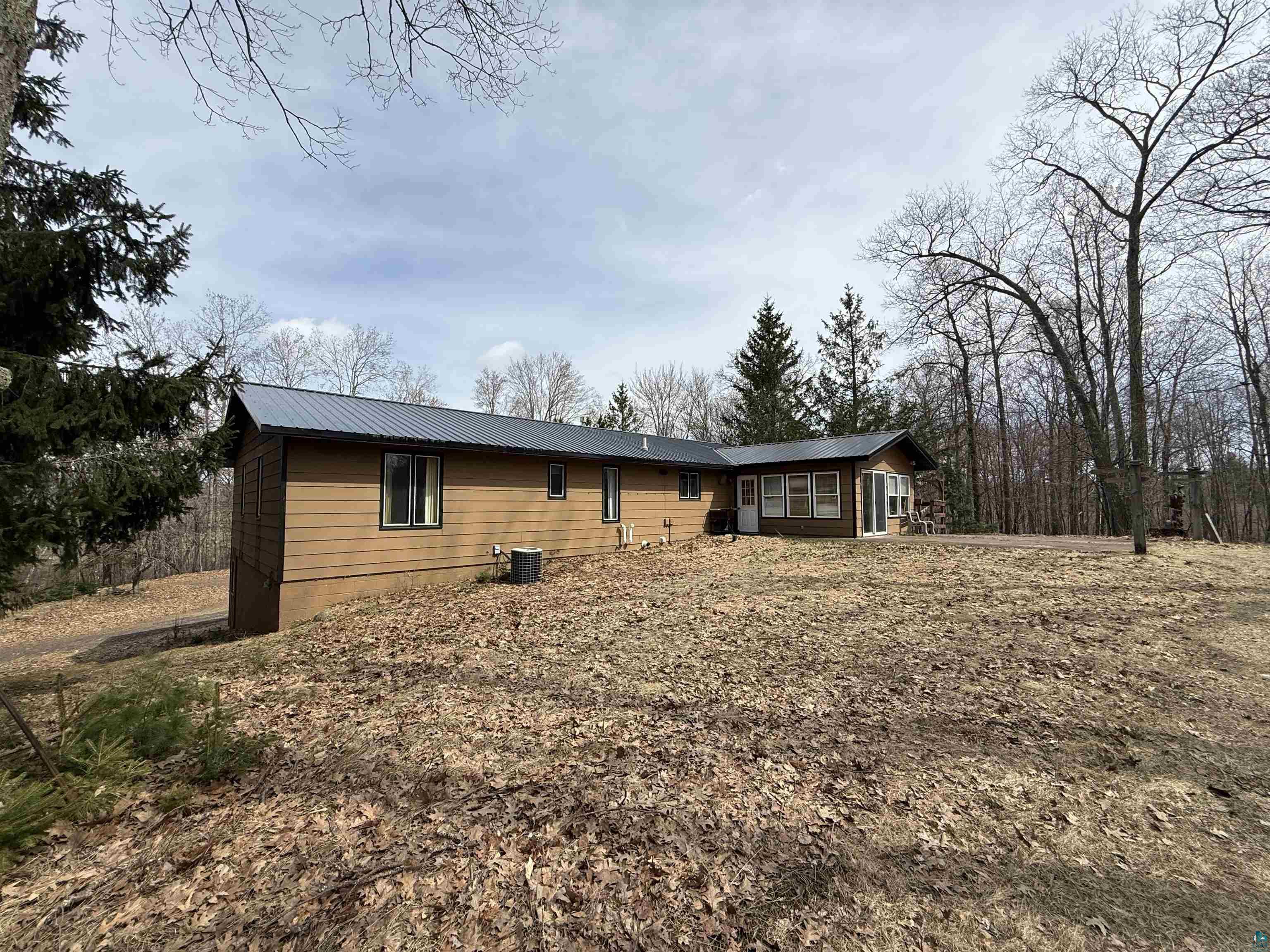 9410 Pine Lake Road Iron River, WI 54847 - Photo 5 of 31 Single-story residence featuring tan siding and a dark gray metal roof