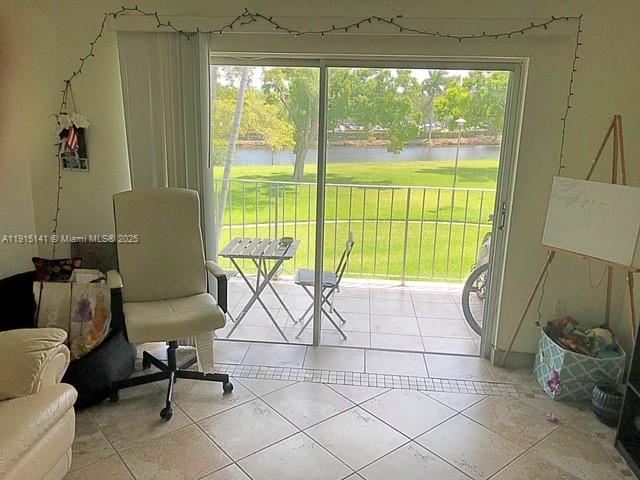 7580 Southwest 82nd Street, Unit F214 Miami, FL 33143 - Photo 5 of 13 a living room with furniture and a floor to ceiling window