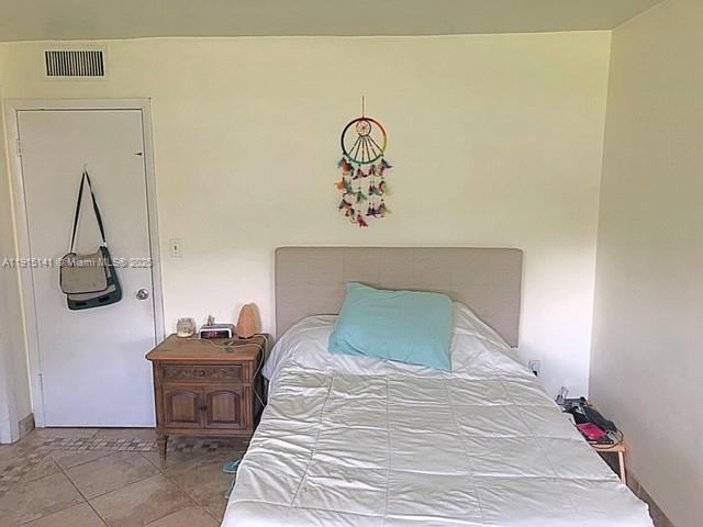 7580 Southwest 82nd Street, Unit F214 Miami, FL 33143 - Photo 10 of 13 a bedroom with a bed and a table