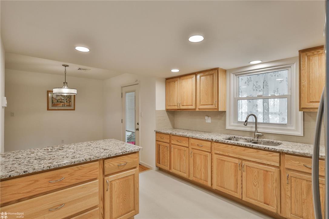 205 West Moorestown Road Wind Gap, PA 18091 - Photo 5 of 20 A well-appointed kitchen features natural wood cabinetry and generous counter space for meal preparation.