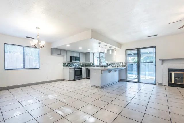 a large white kitchen with a large window and kitchen counter