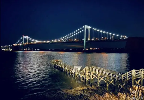 a view of a swimming pool with a garden and deck