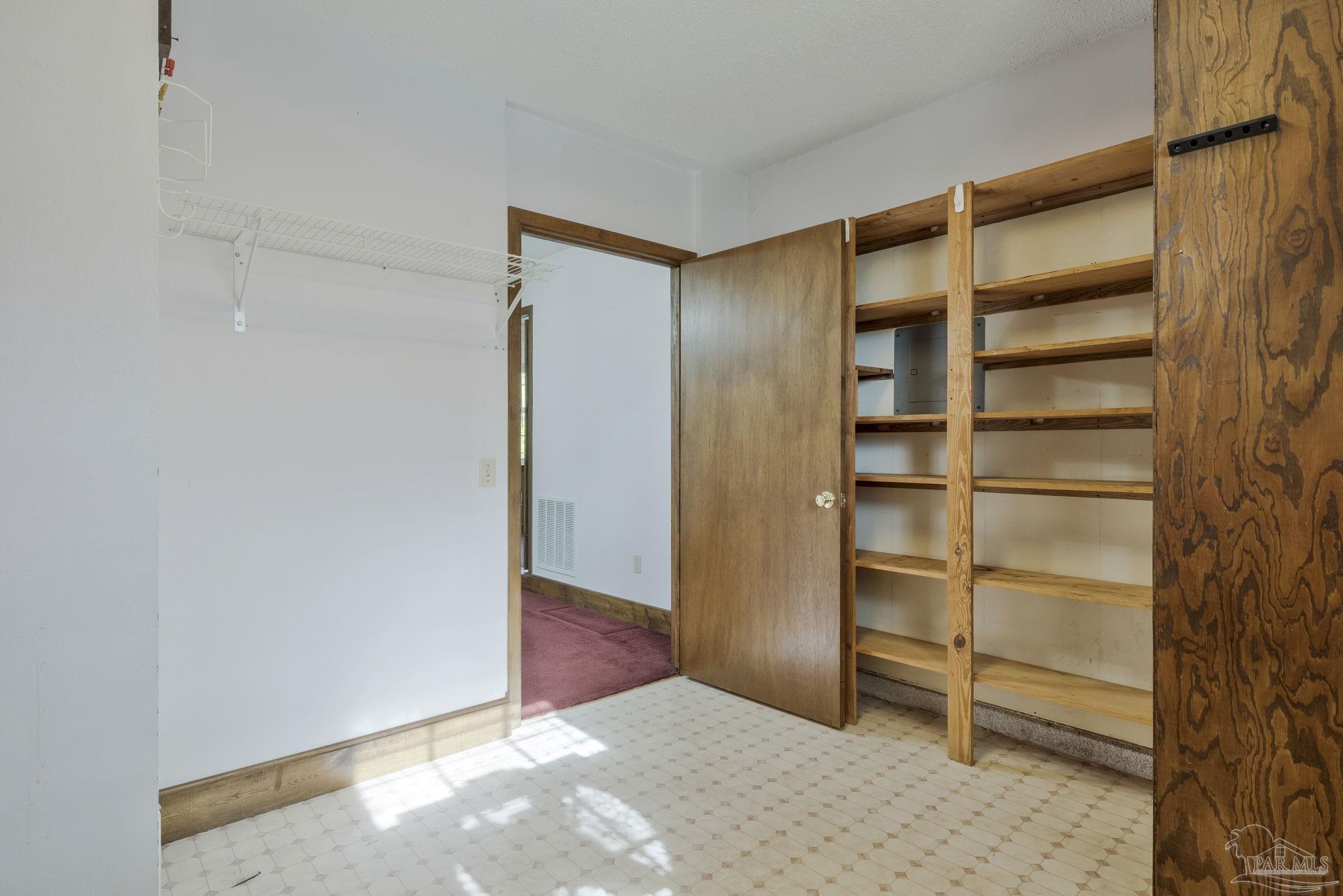 4411 Pace Lane Pace, FL 32571 - Photo 65 of 68 a view of an empty room with cabinet and a window
