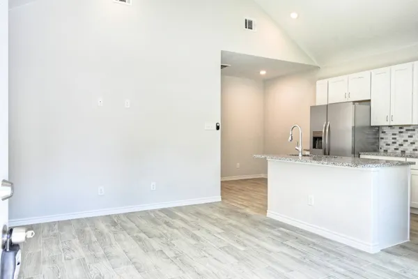 a view of kitchen with refrigerator sink and wooden floor