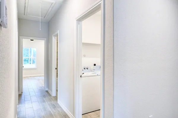 a view of a hallway with wooden floor