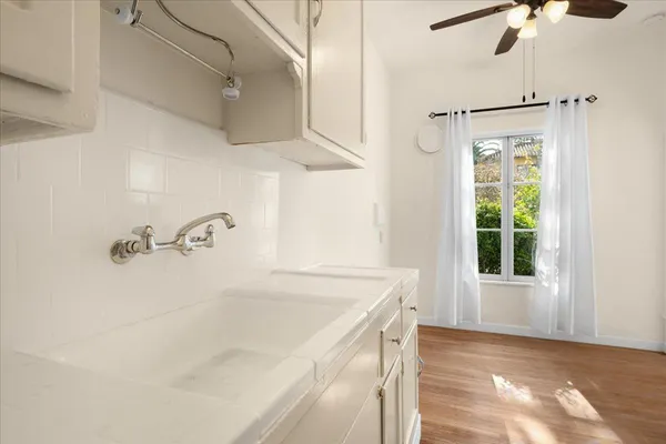 a bathroom with a tub sink and mirror