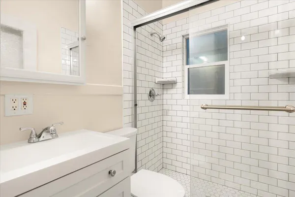 a bathroom with a sink toilet and shower