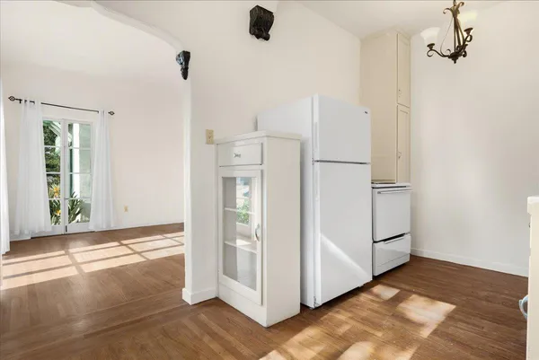 a view of kitchen with refrigerator and window
