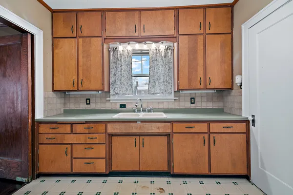 a kitchen with granite countertop cabinets and window