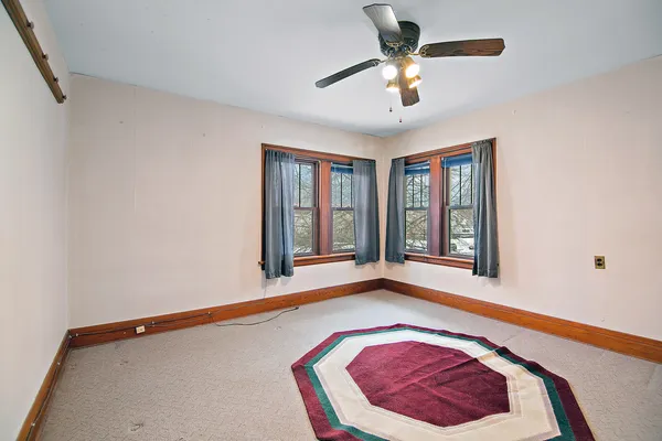 a view of a room with window and ceiling fan