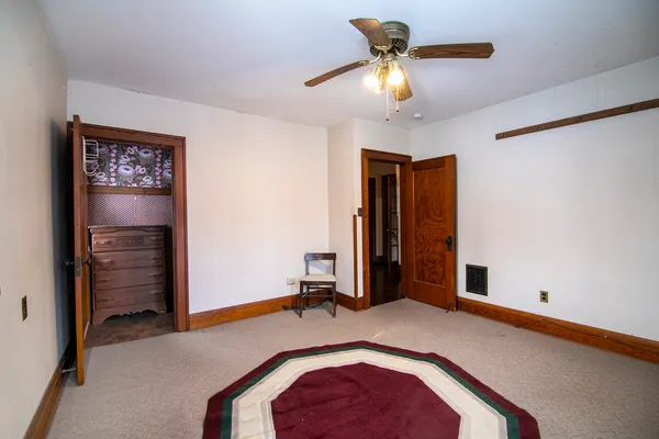 a bedroom with bed and a chandelier