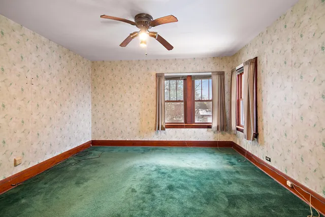 a view of room with window and ceiling fan