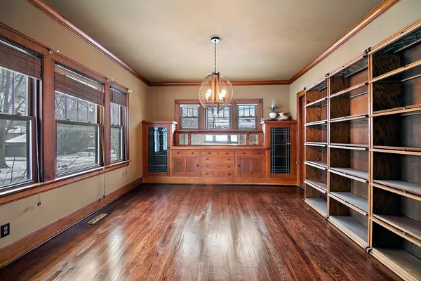 a view of a room with wooden floor and windows