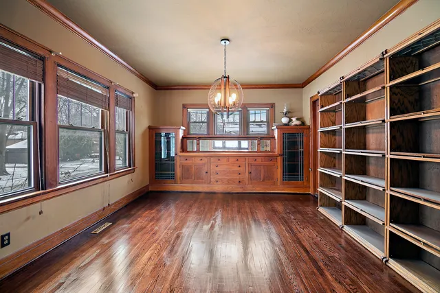 a view of a room with wooden floor and windows