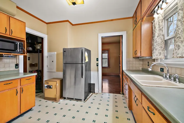 a kitchen with a refrigerator and a sink