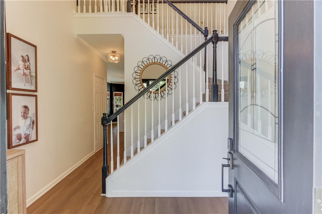 2310 Olde Hickory Place Monroe, GA 30656 - Photo 4 of 46 a view of staircase with wooden floor and white walls