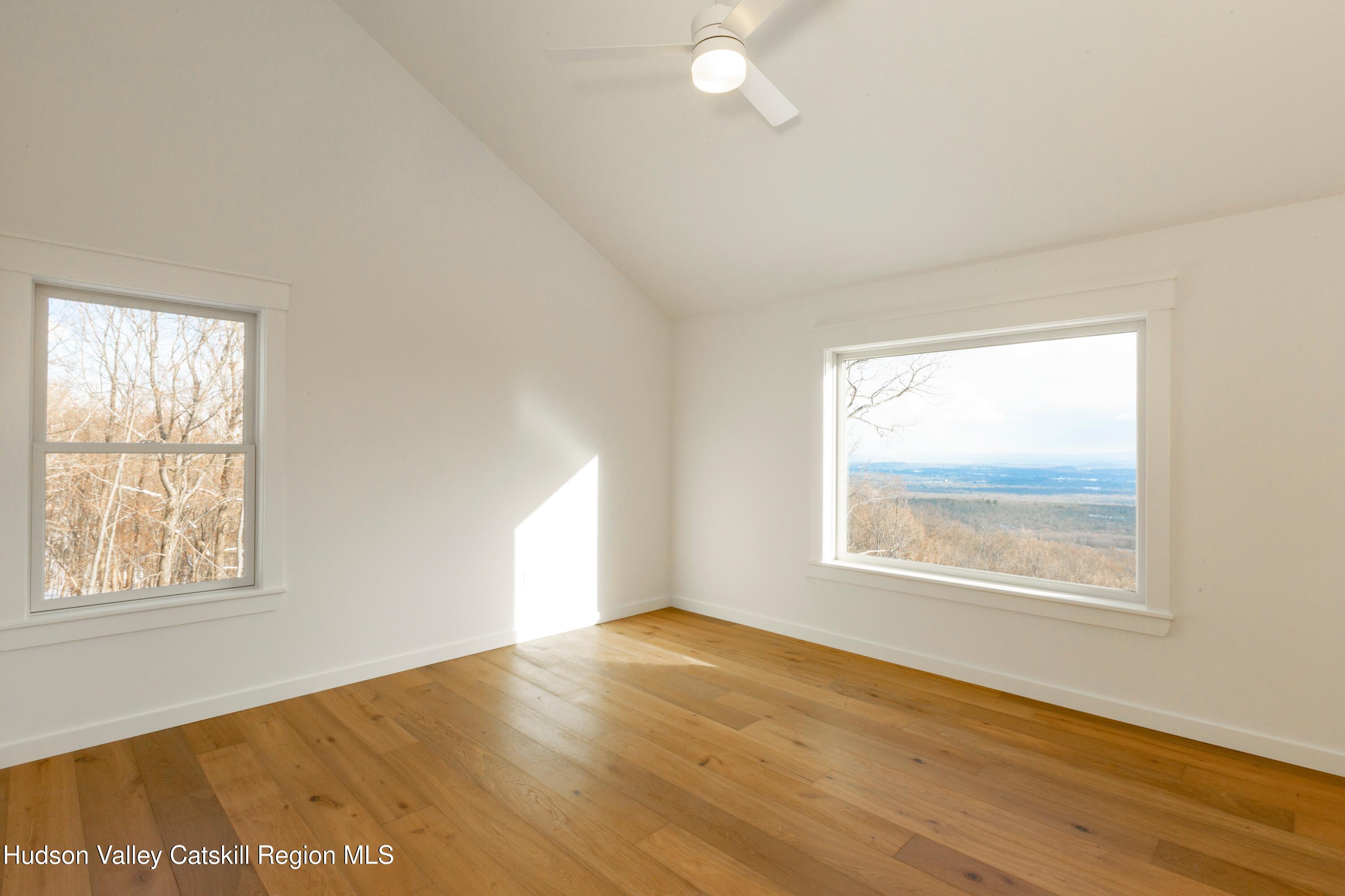 368 Marl Road Pine Bush, NY 12566 - Photo 19 of 29 an empty room with wooden floor and windows