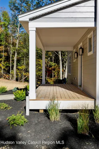 a view of a room with wooden floor and a window