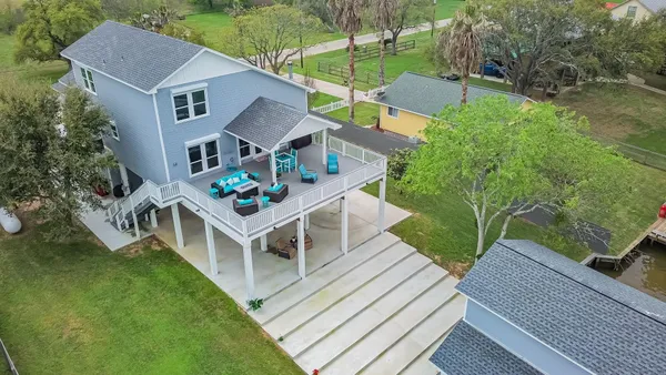 a house with green field in front of it