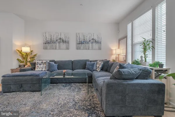 a living room with furniture and a large window