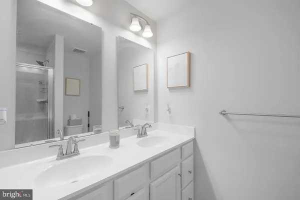 a bathroom with a double vanity sink and a mirror