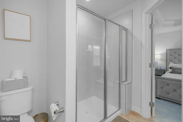 a bathroom with a shower a toilet and sink