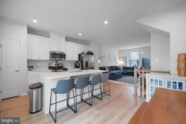 a kitchen with sink a counter top space cabinets and stainless steel appliances