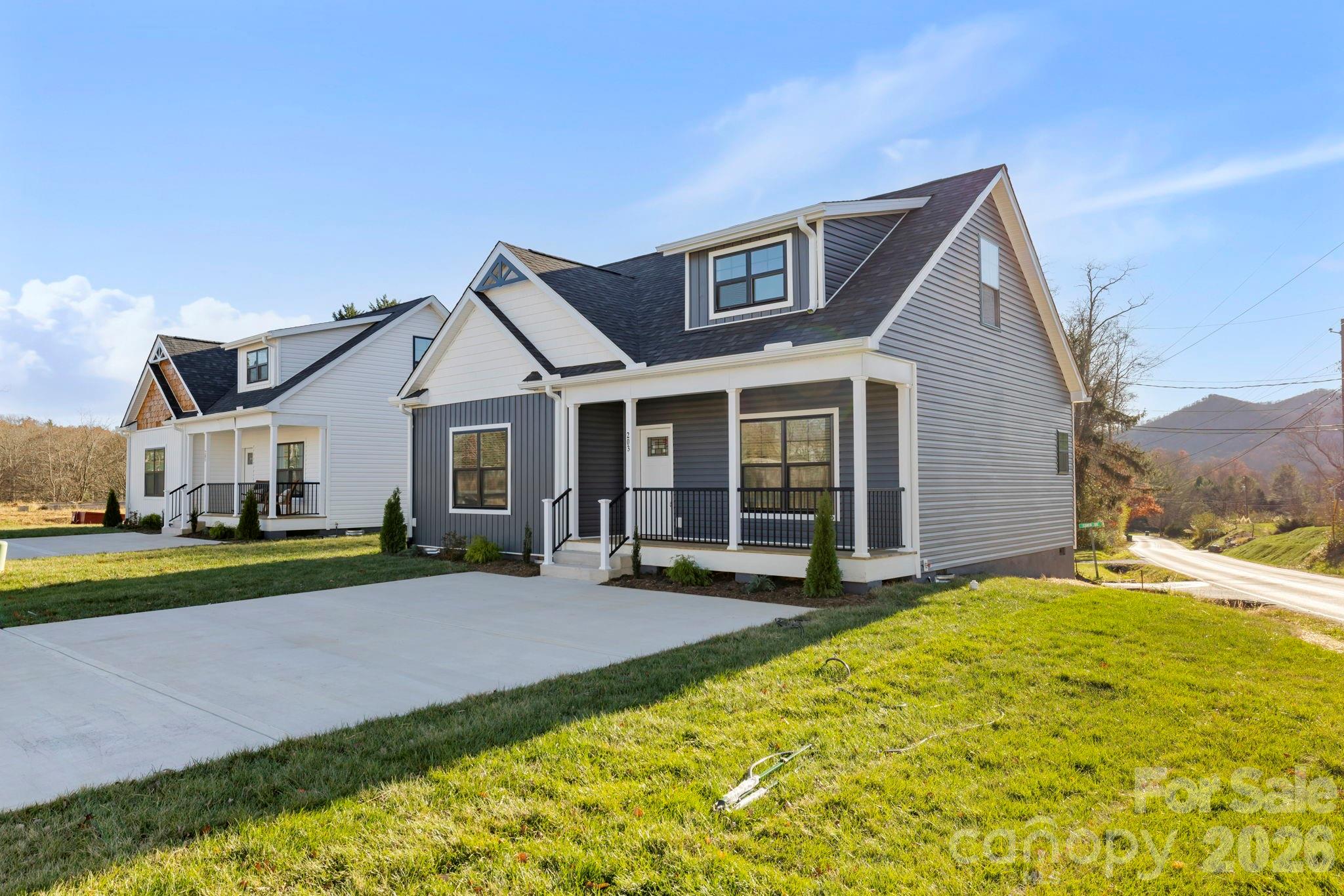 a view of a house with a yard and large tree