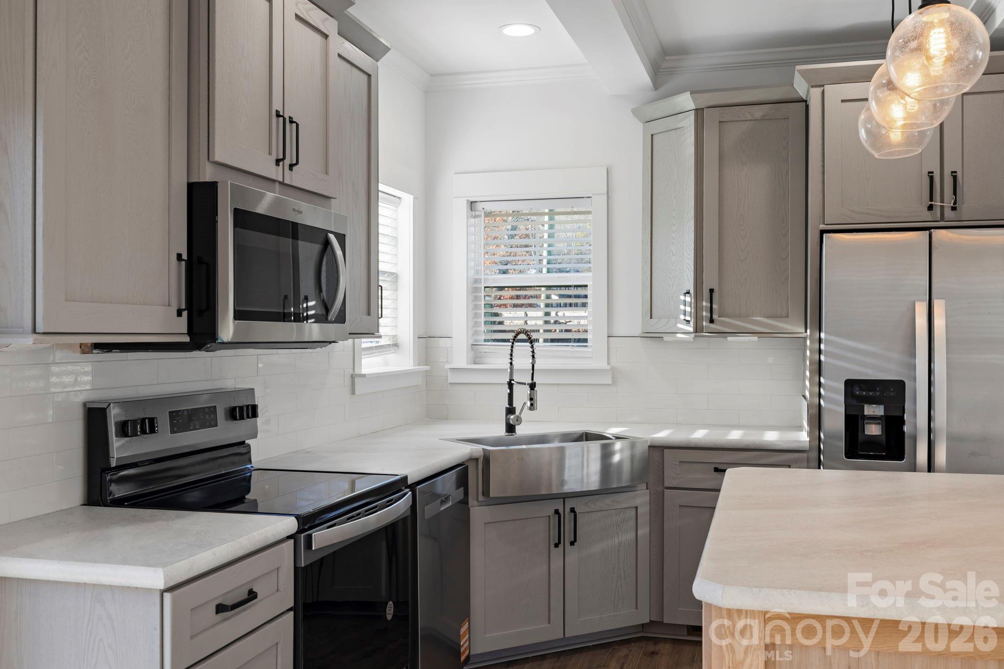 203 Southern Charm Road Arden, NC 28704 - Photo 12 of 34 a kitchen with stainless steel appliances granite countertop a stove sink and microwave