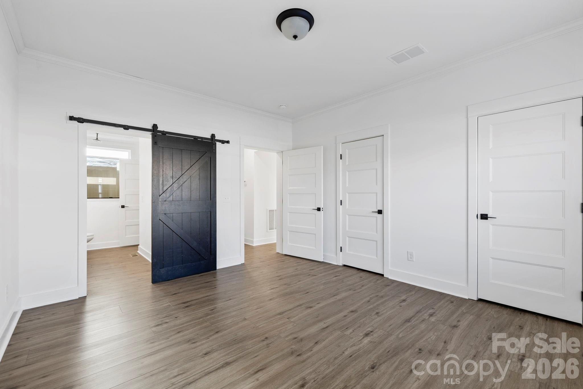 203 Southern Charm Road Arden, NC 28704 - Photo 14 of 34 a view of an empty room with wooden floor and closet