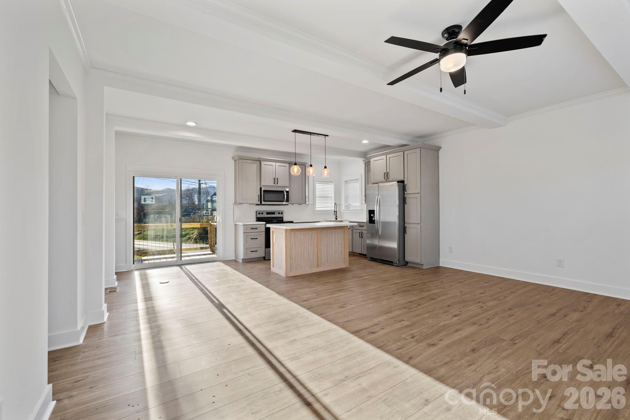 203 Southern Charm Road Arden, NC 28704 - Photo 4 of 34 a large white kitchen with stainless steel appliances kitchen island granite countertop a refrigerator and cabinets