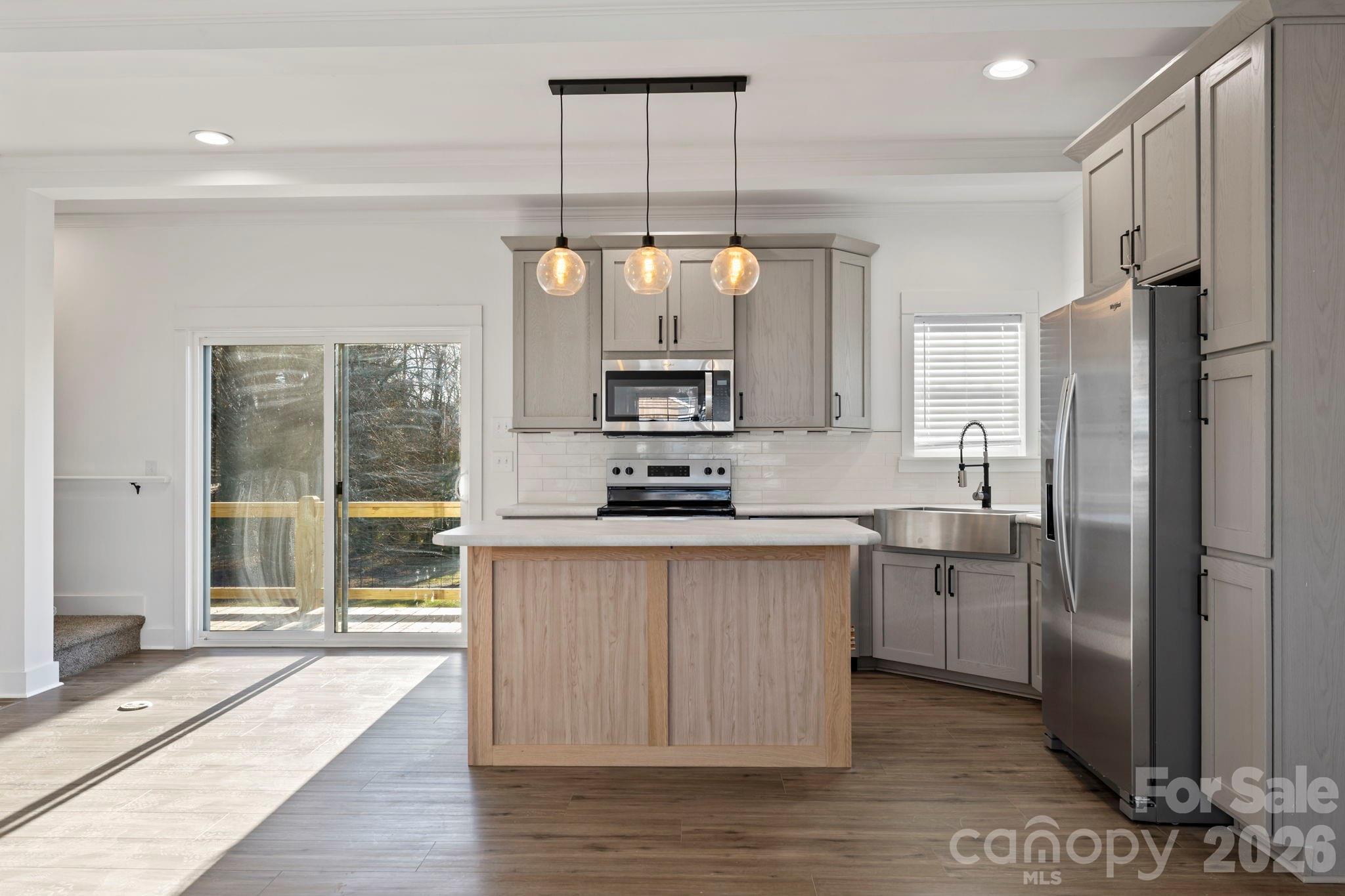 203 Southern Charm Road Arden, NC 28704 - Photo 9 of 34 a kitchen with stainless steel appliances granite countertop a refrigerator a sink dishwasher a stove and a refrigerator with wooden floor