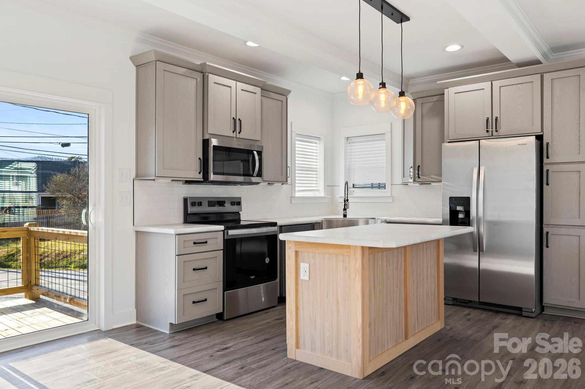 203 Southern Charm Road Arden, NC 28704 - Photo 10 of 34 a kitchen with stainless steel appliances granite countertop a refrigerator a stove a sink and a microwave