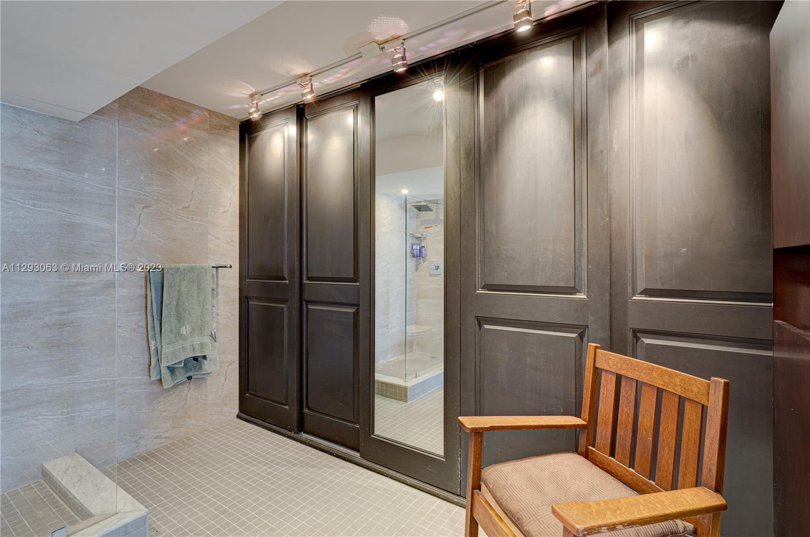 600 Northeast 36th Street, Unit 701 Miami, FL 33137 - Photo 11 of 19 a bathroom with a mirror and a shower