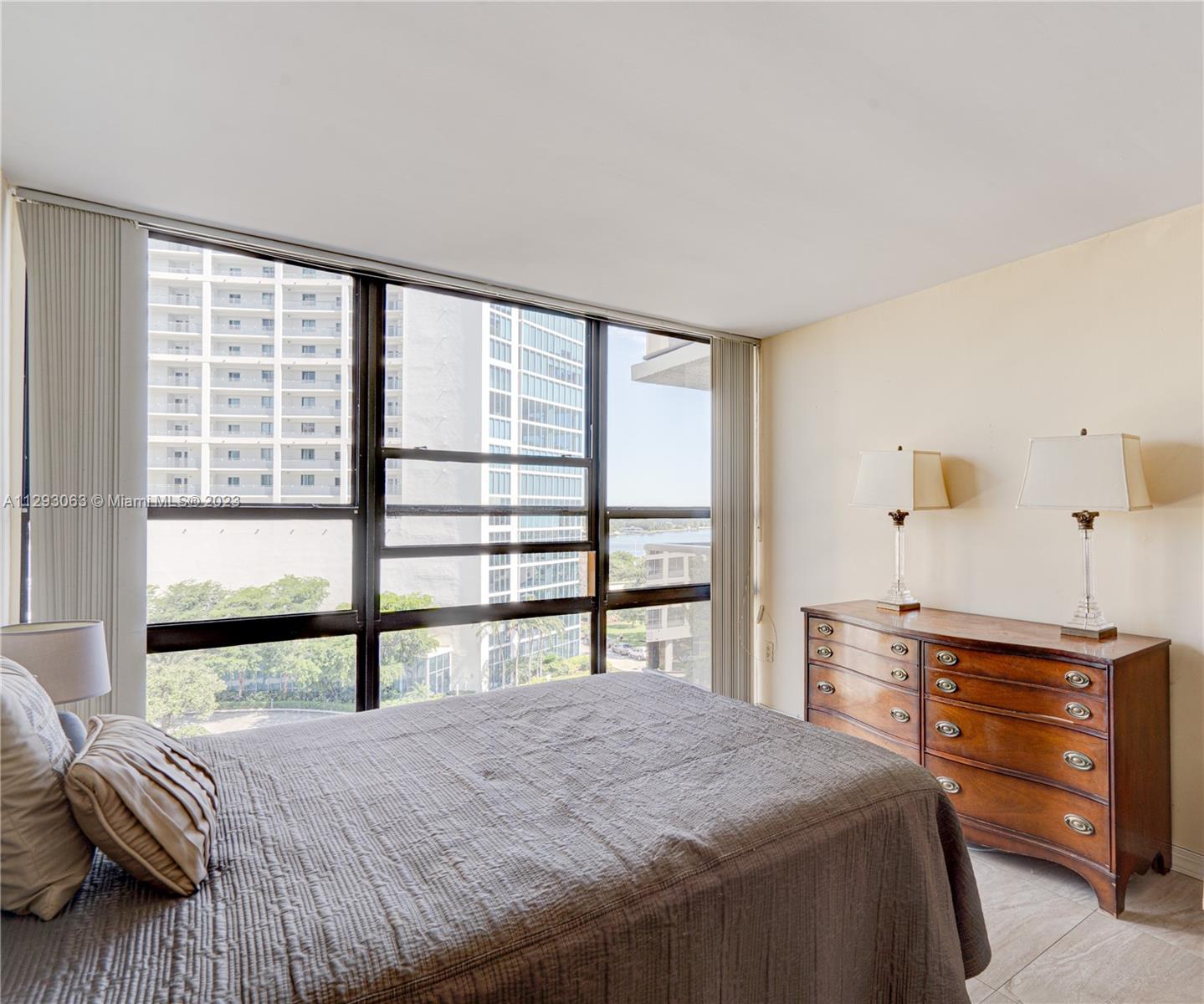 600 Northeast 36th Street, Unit 701 Miami, FL 33137 - Photo 12 of 19 a bedroom with a bed and a large window