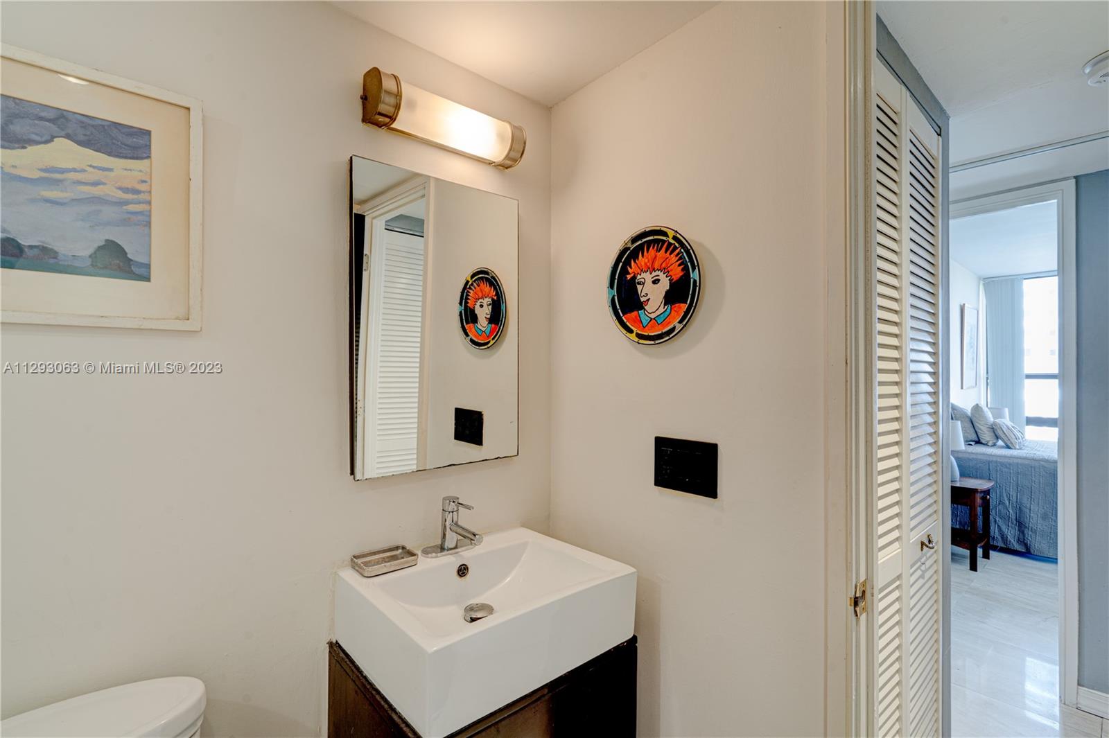 600 Northeast 36th Street, Unit 701 Miami, FL 33137 - Photo 16 of 19 a bathroom with a sink and a mirror