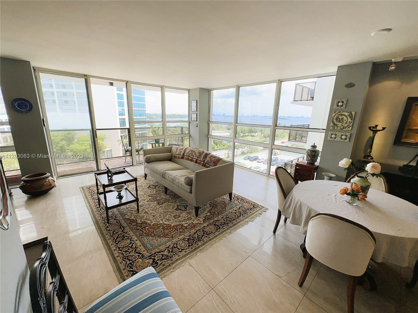 600 Northeast 36th Street, Unit 701 Miami, FL 33137 - Photo 3 of 19 a living room with furniture and a floor to ceiling window