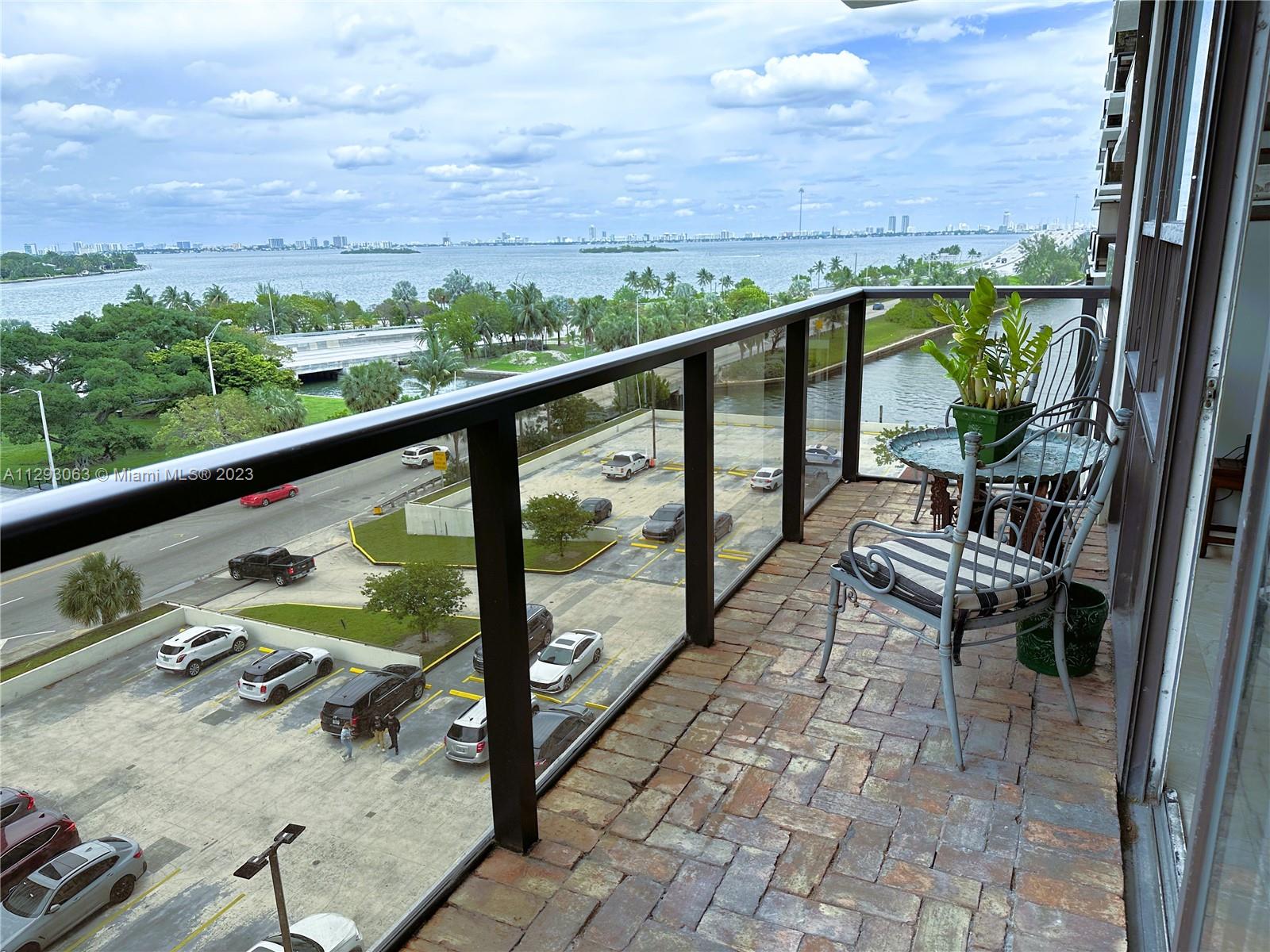 600 Northeast 36th Street, Unit 701 Miami, FL 33137 - Photo 4 of 19 a view of a balcony with chairs and wooden fence