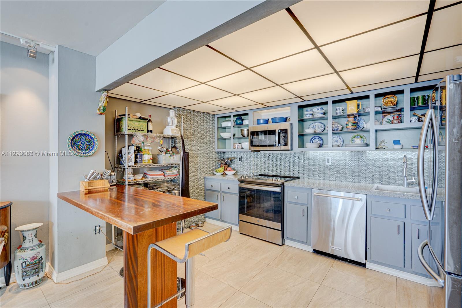 600 Northeast 36th Street, Unit 701 Miami, FL 33137 - Photo 6 of 19 a kitchen with stainless steel appliances granite countertop a sink and cabinets