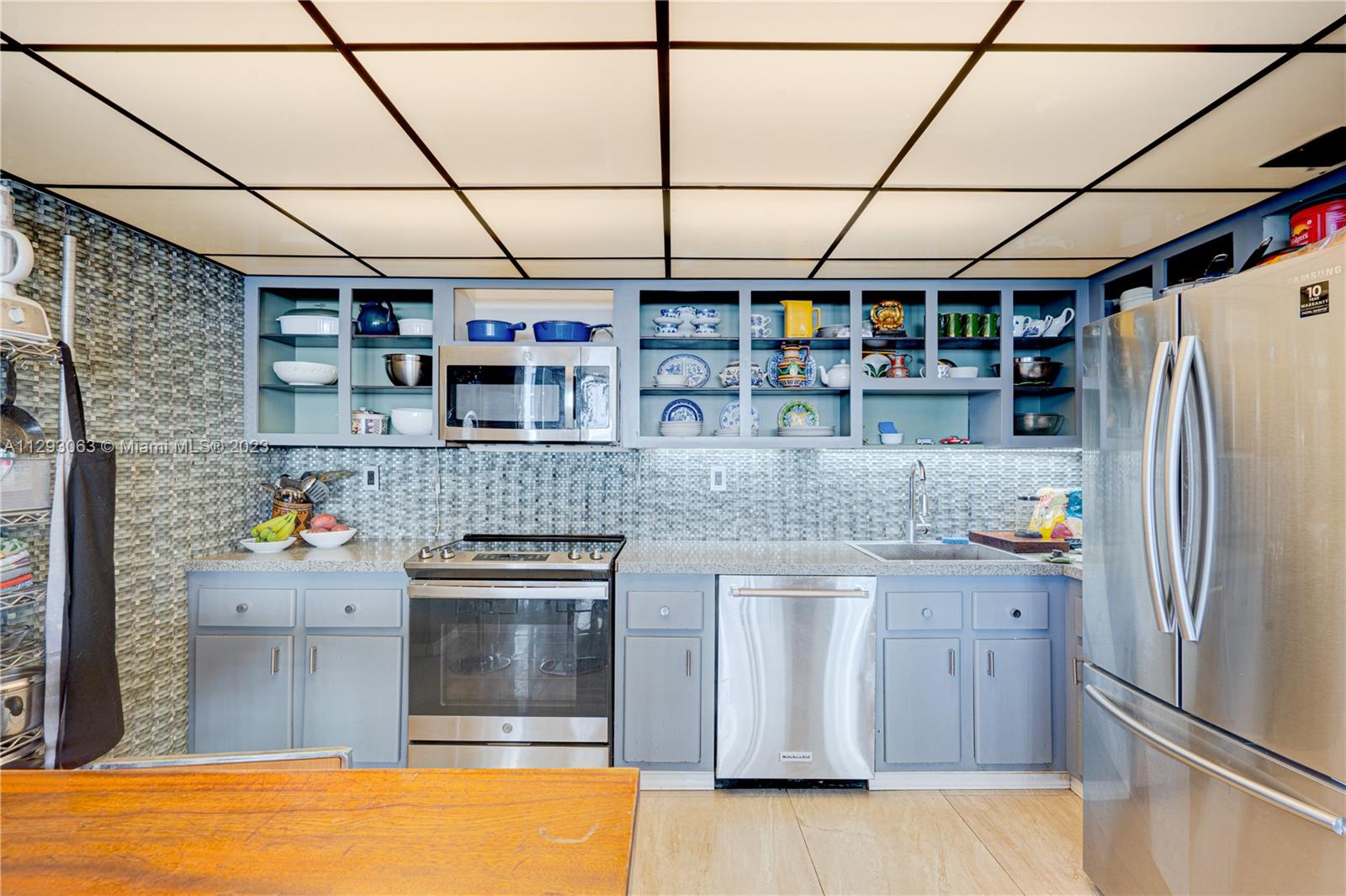 600 Northeast 36th Street, Unit 701 Miami, FL 33137 - Photo 7 of 19 a kitchen with a refrigerator and a sink