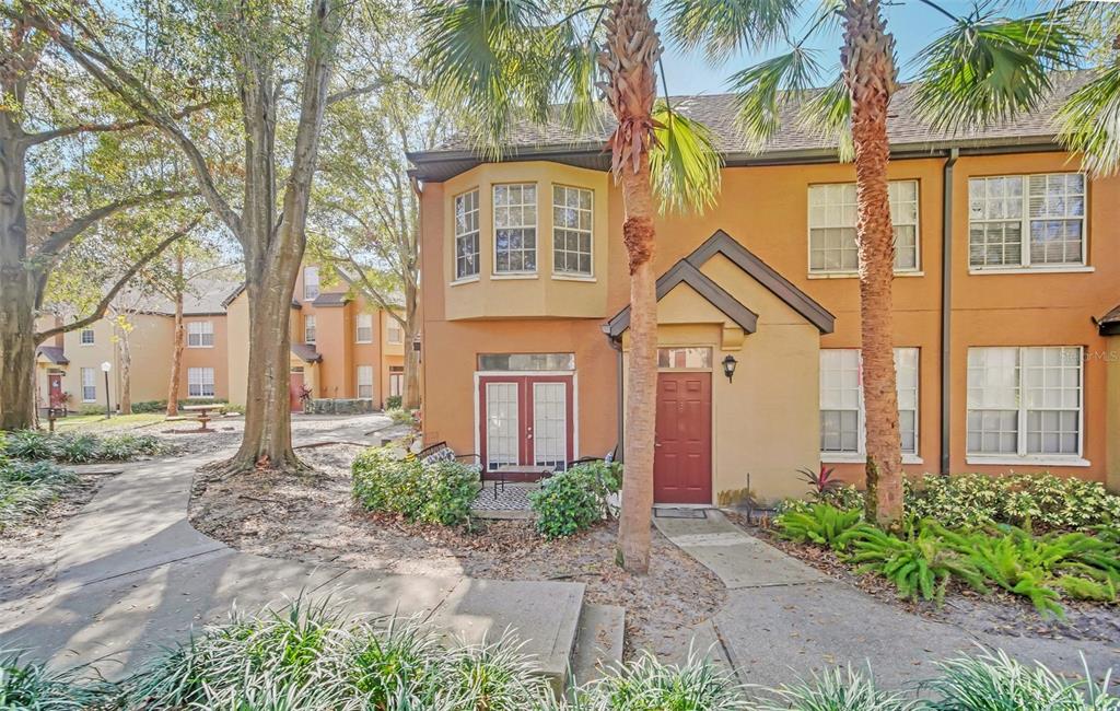 6356 Raleigh Street, Unit 1512 Orlando, FL 32835 - Photo 1 of 1 front view of a house with a small yard