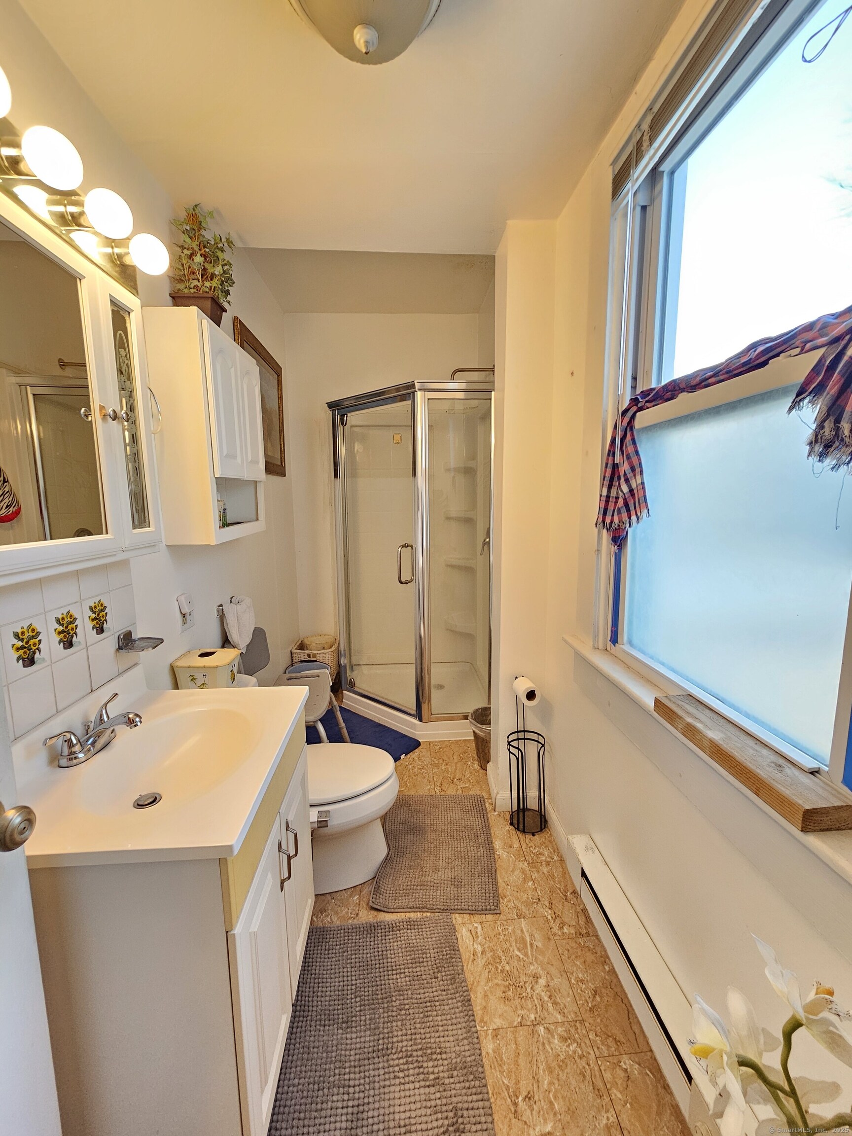 42 Washington Street Wallingford, CT 06492 - Photo 11 of 15 a bathroom with a sink a toilet and shower